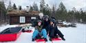 group of young people with tobogganing