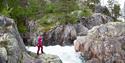 lady standing by a waterfall on Haukeli