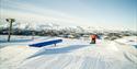 snowboarder drives on terrain park at Rauland ski center