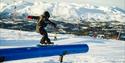 with snowboard in terrain park to Rauland ski center