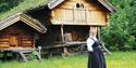 lady in front of storage shed at Tuddal bygdetun