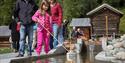 girl locks a boat on the miniature version of the telemark canal in the canal park at Vest-Telemark Museum in Eidsborg