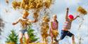 children jumping in the hay