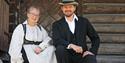 woman and man in traditional clothes at Heddal bygdetun in Notodden