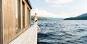 couple sitting on the deck of Dugg sauna in Notodden