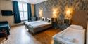 large room with 3 beds at Hotel Vic