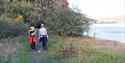 Lady with two boys on a trip on the coastal path between Brevik and Skjelsvik