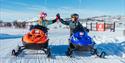 girls riding snowmobiles