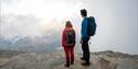 couple on top of Gaustatoppen in foggy weather