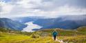 lady walking on mount Skorve with a view of seljordvatn