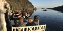 Group eating by the sea