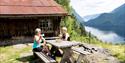 2 ladies sitting in front of the cottage on Rui Square enjoying a cup of coffee