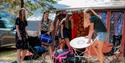 girls unpack tents and equipment at Telnessanden camping