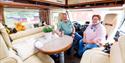 elderly couple sitting in their motorhome