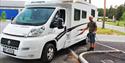 man fills water on his motorhome in motorhome parking in Skien leisure park