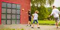 man and 2 boys play with electronic ball game at Foldvik family park