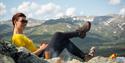 lady sitting on the mountain and enjoying a coffee