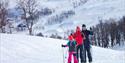 family of 3 cross-country skiing at Rauland