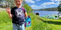 girl at Hulfjell family park with water park in the background