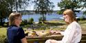 Two girls enjoying food on Bjørkøya in Porsgrunn.