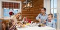 family eating Christmas dinner in a cabin at Rauland Feriesenter