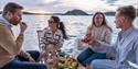 group of friends eat on board the boat to Canal Boats Telemark