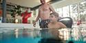 father and son in a wheelchair in the swimming pool in Skien leisure park