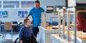 boy in a wheelchair with his father at the breakfast buffet in Hotell fritidsparken