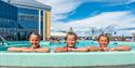 3 children look over the pool edge at the outdoor pool to Badeparken at Quality Hotel Skjærgården in Langesund