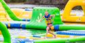boy runs over obstacles at Hulfjell water park in Drangedal