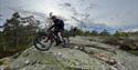 cyclist rides on svaberg