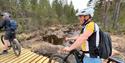 cyclists cycle across a path of planks