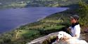 Lady with dog enjoying the view over water in Fyresdal