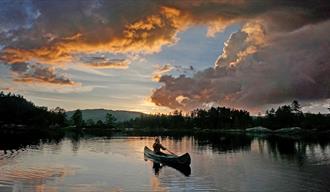 man paddling in a canoe at Fiskebusøylen