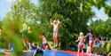 children jump on a bouncy castle in Foldvik family park