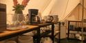 Kitchen tent with plates, glasses and other kitchen equipment at Lystang Glamping