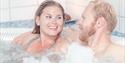 man and woman relax in a jacuzzi at the Spa and wellness department in Skien leisure park