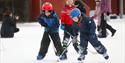 barn spiller ishokey på skøytebanen i Skien fritidspark
