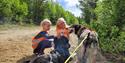 2 girls pet the dogs from Telemark Husky Tours
