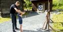 A little boy tries archery at Vest-Telemark Museum Eidsborg.