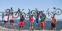 gruppe syklister som holder syklene sine i lufta