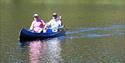 2 men paddling in a canoe