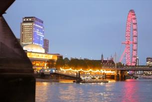 View of the London Eye at night from City Cruises