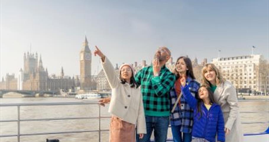 Family on City Cruises boat trip with Big Ben behind