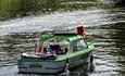 People in motor boat on the river thames