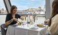 People eating at a table on a boat