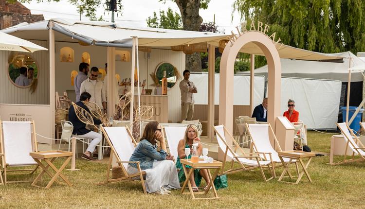 People sitting outside Pavilion for hire at Henley Royal Regatta