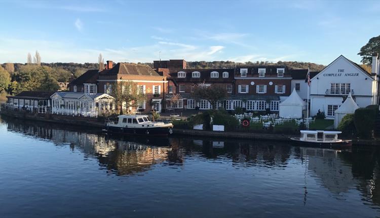 View of Macdonald Compleat Angler from river with boats moored.