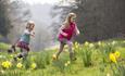 Children running through daffodils at Cliveden in the springtime, image copyright Chris Lacey