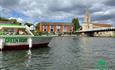 The Little Green Boat heading towards Marlow Bridge and the Church on the Thames at Marlow.